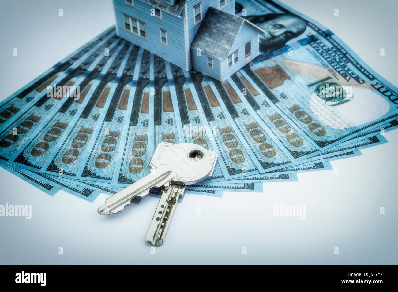 close up of home model, dollar money and house keys Stock Photo