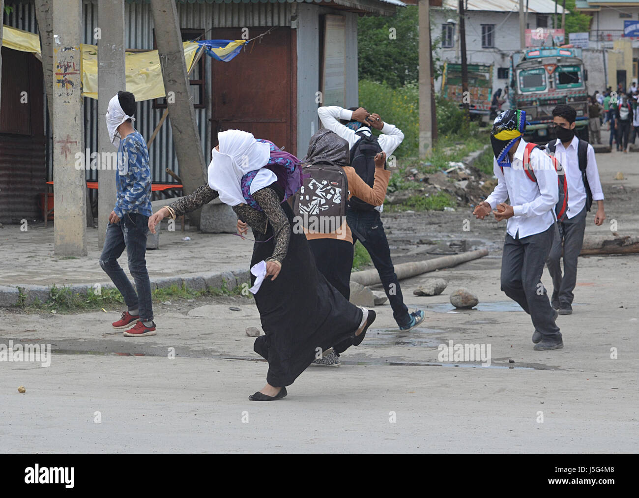 Kashmir. 17th May, 2017. Female students throw stones during clashes in