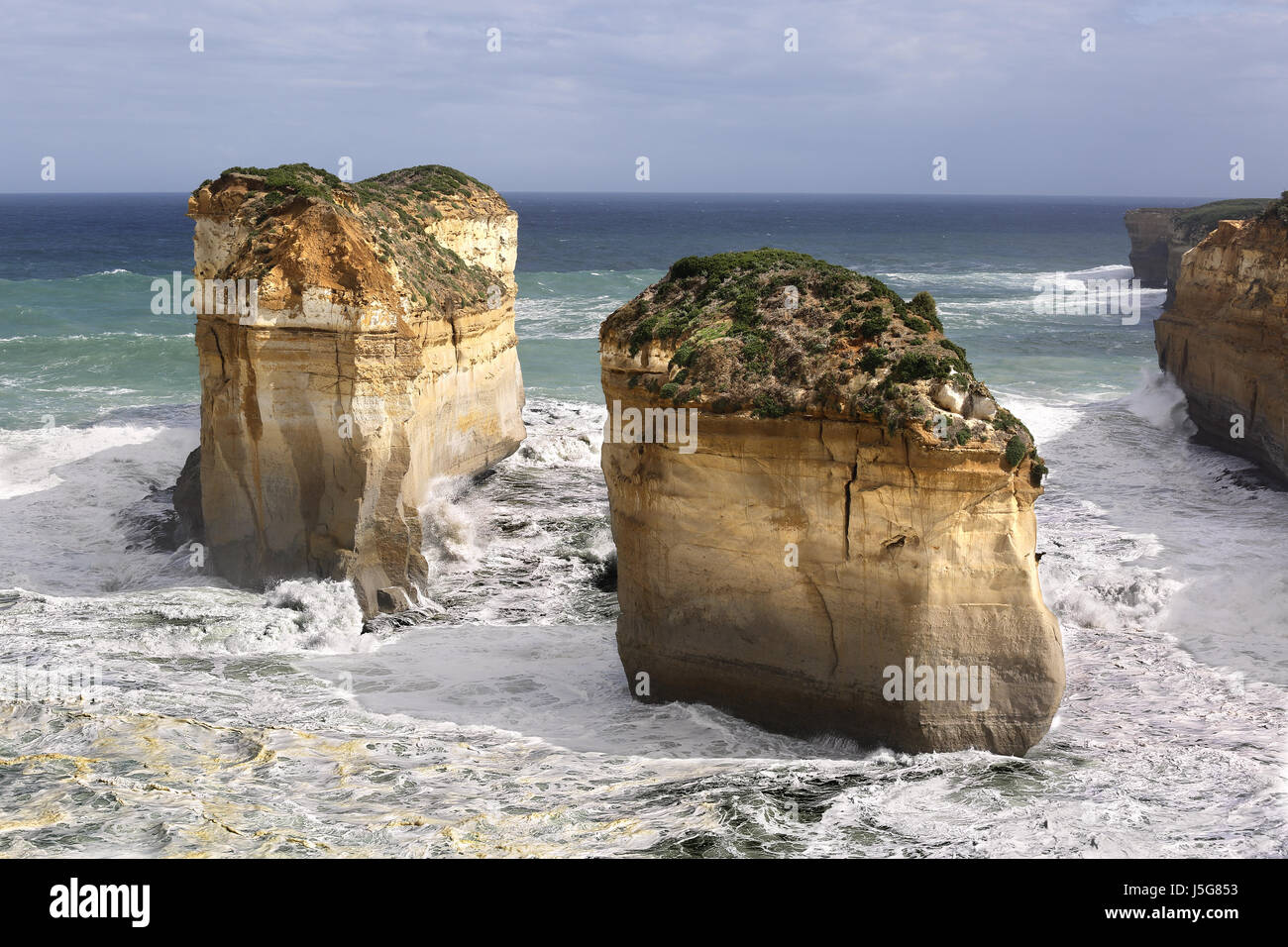 Swirling water around two of the 'Twelve Apostles' limestone stacks, in the sea in Victoria, Australia Stock Photo