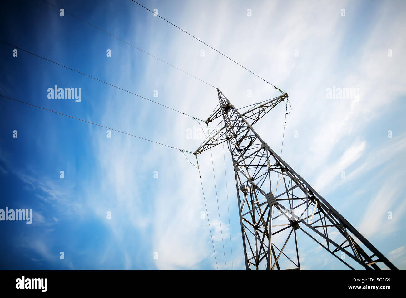 High voltage electricity pylon against blue sky Stock Photo - Alamy