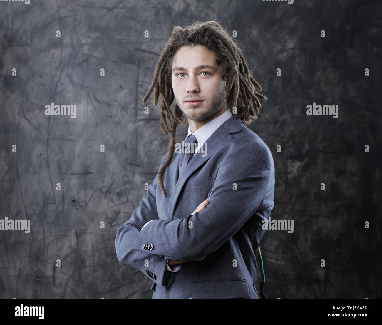 Portrait of a young businessman with arms crossed Stock Photo - Alamy