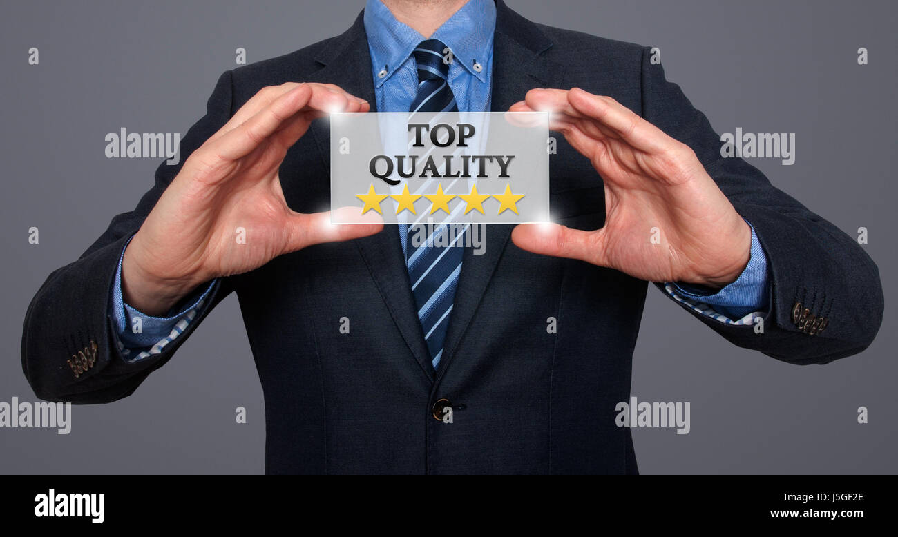 TOP Quality with five stars - Businessman with sign - Grey - Stock Photo Stock Photo
