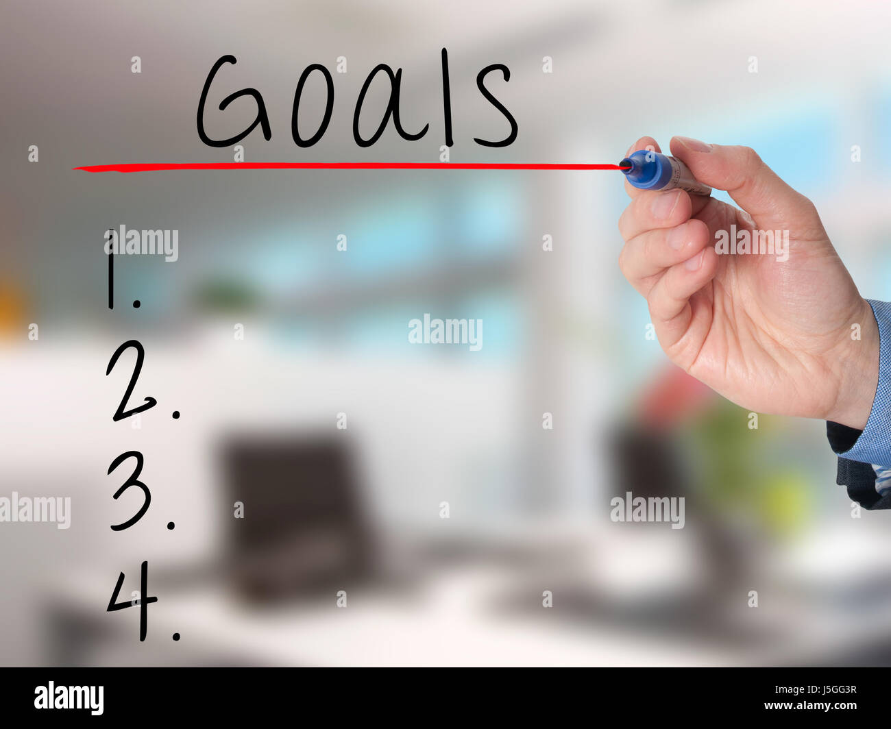 Businessman is writing goals list, planning on whiteboard. Isolated on