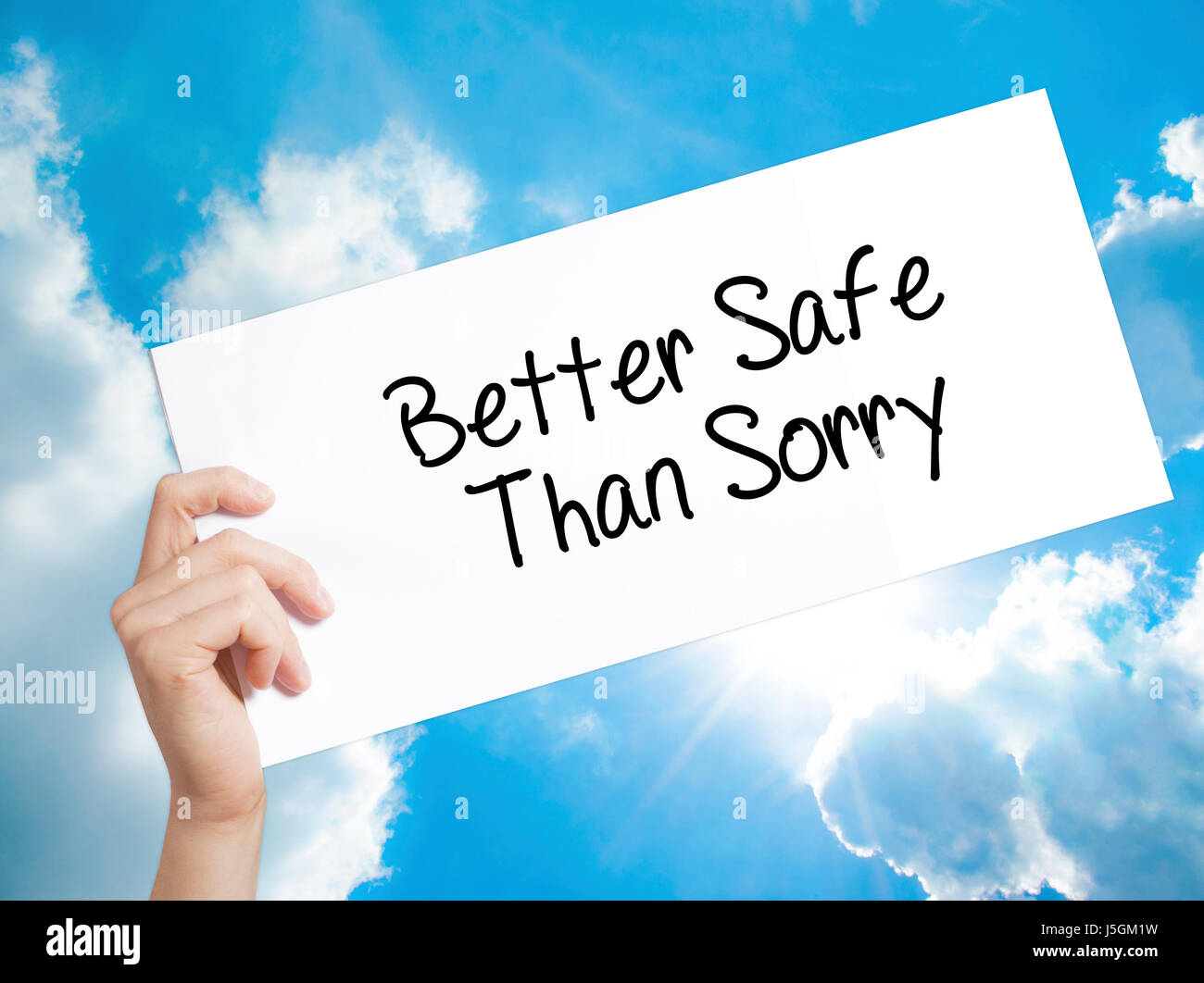 Better Safe Than Sorry Sign on white paper. Man Hand Holding Paper with text. Isolated on sky