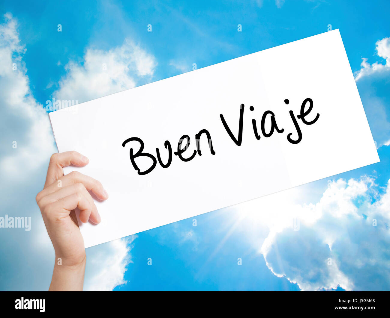 Buen Viaje (Good Trip in Spanish) Sign on white paper. Man Hand Holding Paper with text. Isolated on sky background.   Business concept. Stock Photo Stock Photo