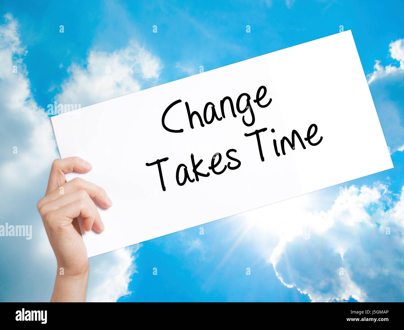 Change Takes Time Sign on white paper. Man Hand Holding Paper with text