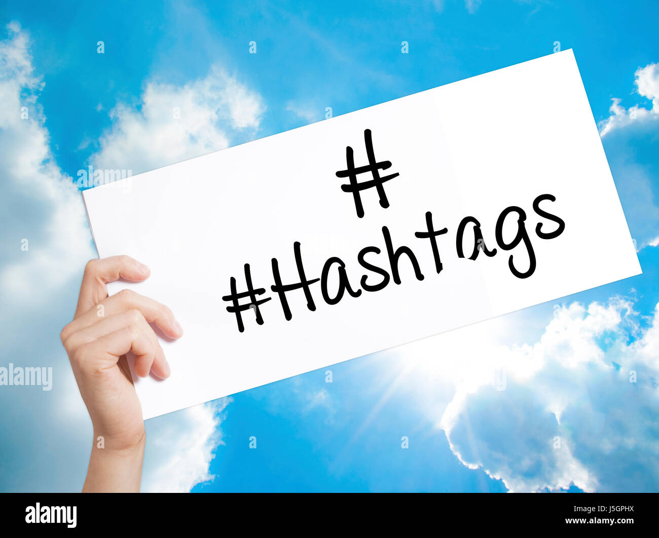 #Hashtags Sign on white paper. Man Hand Holding Paper with text ...