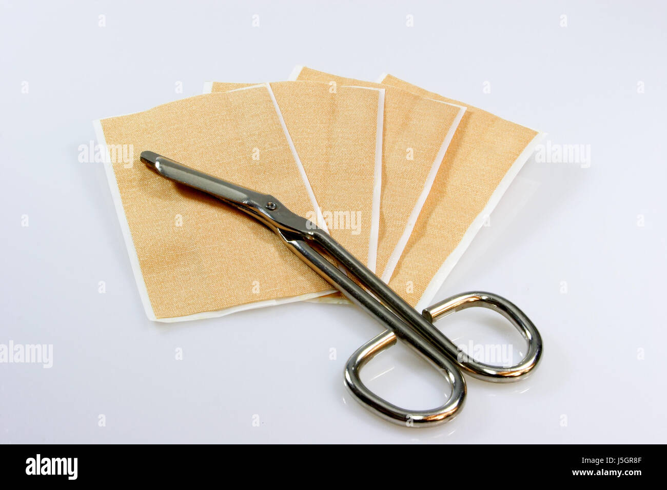 plaster wound injury scissors scissor means agent medicine drug remedy Stock Photo