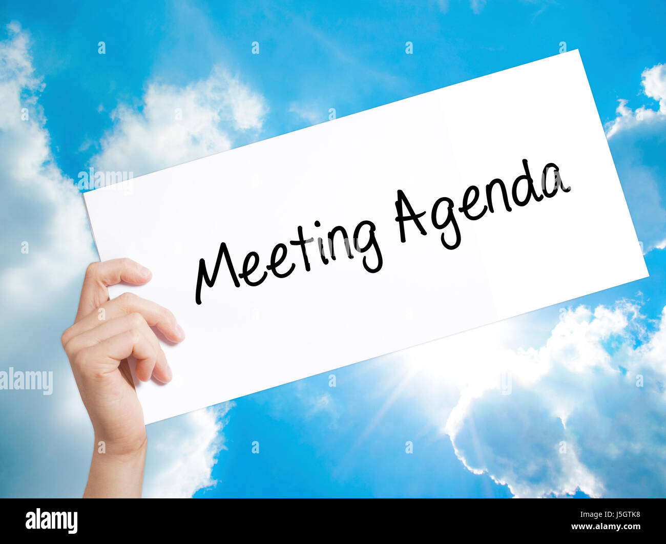 Meeting Agenda Sign On White Paper Man Hand Holding Paper With Text Isolated On Sky Background Business Concept Stock Photo Stock Photo Alamy