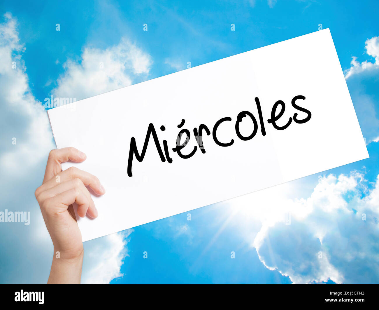 Miercoles (Wednesday in Spanish) Sign on white paper. Man Hand Holding  Paper with text. Isolated on sky background. Business concept. Stock Photo  Stock Photo - Alamy