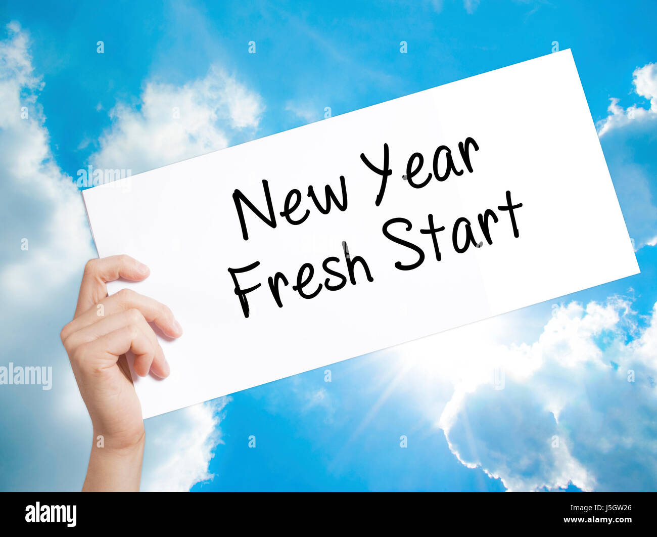 New Year Fresh Start Sign on white paper. Man Hand Holding Paper with