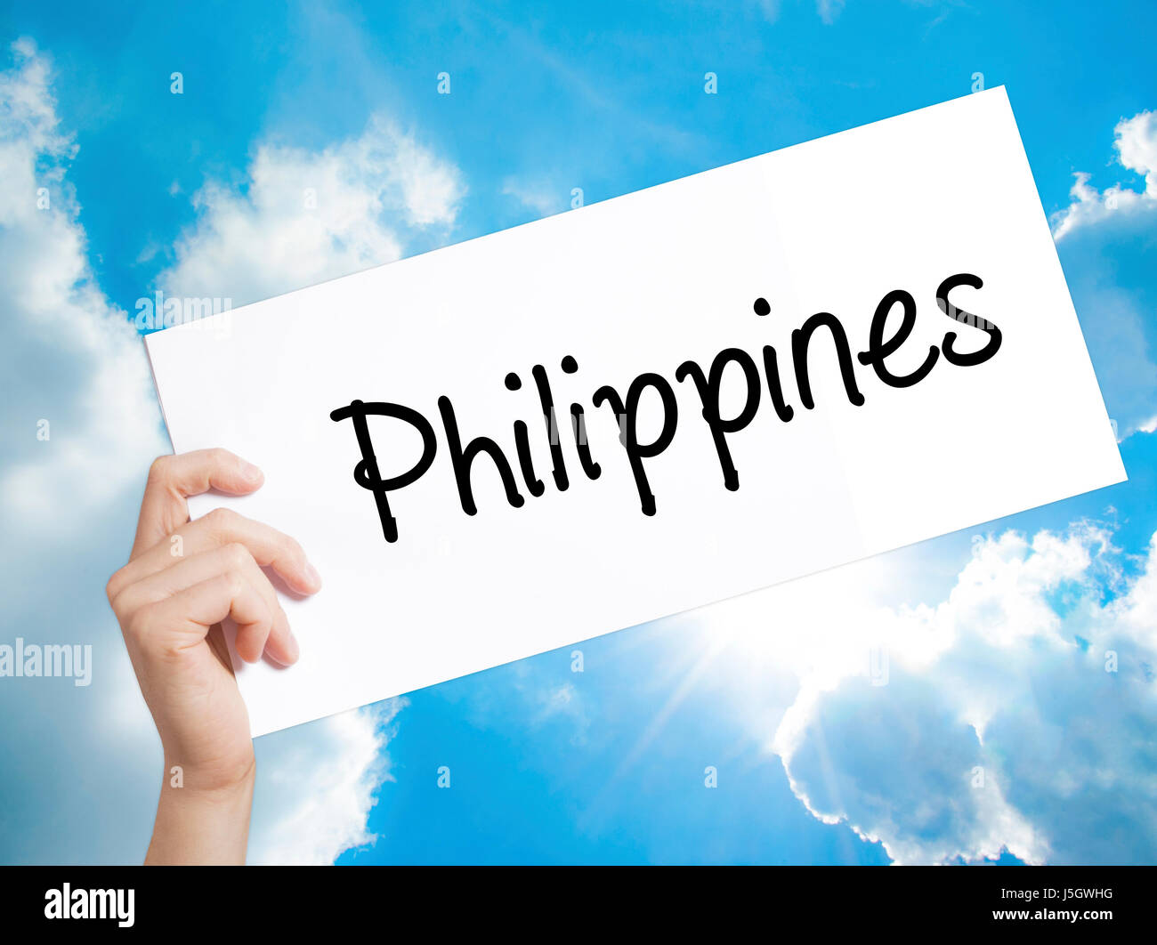 Philippines Sign on white paper. Man Hand Holding Paper with text. Isolated on sky background.   Business concept. Stock Photo Stock Photo