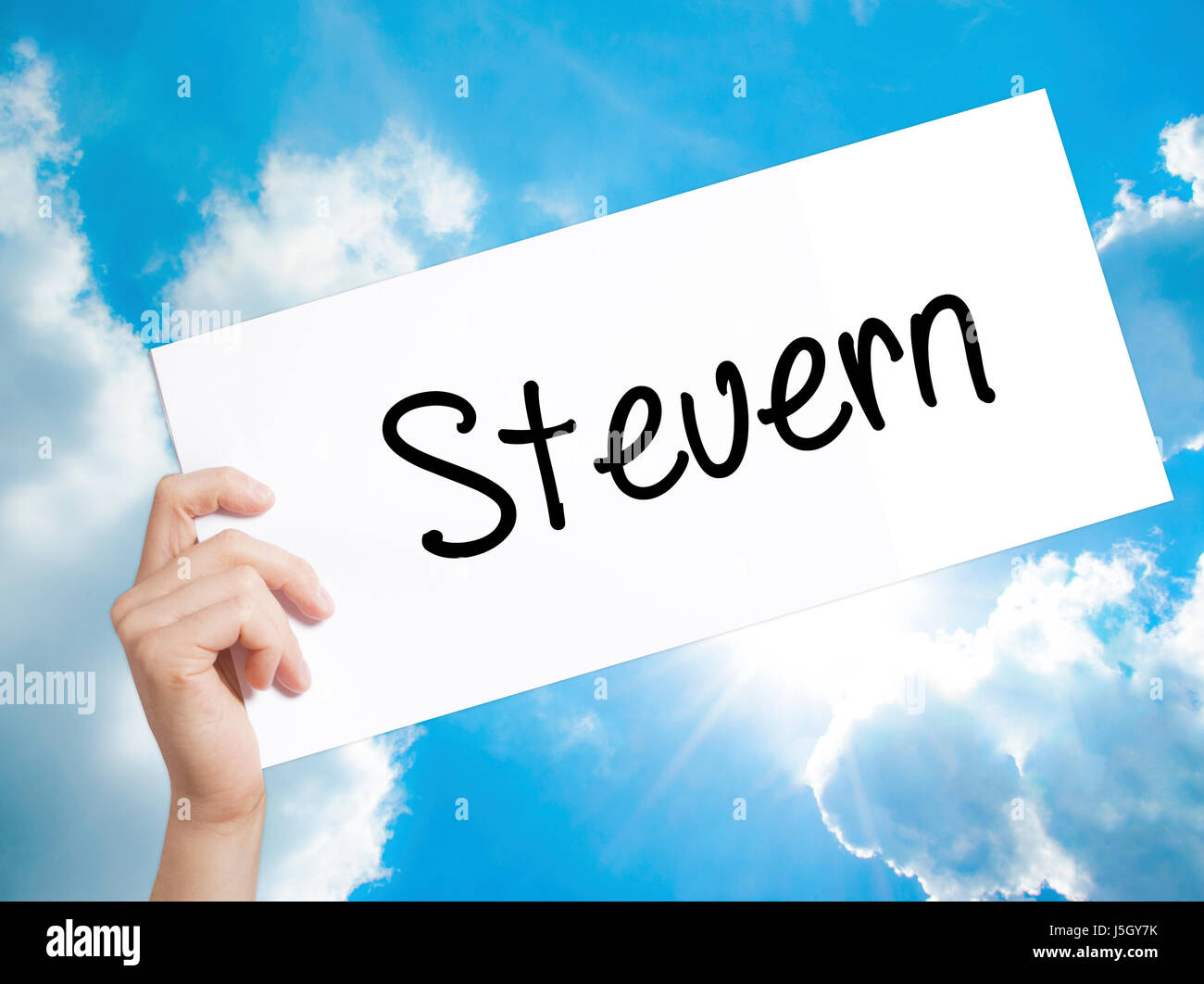 Steuern (German Tax) Sign on white paper. Man Hand Holding Paper with text. Isolated on sky background. Isolated on background. Business,   Business c Stock Photo