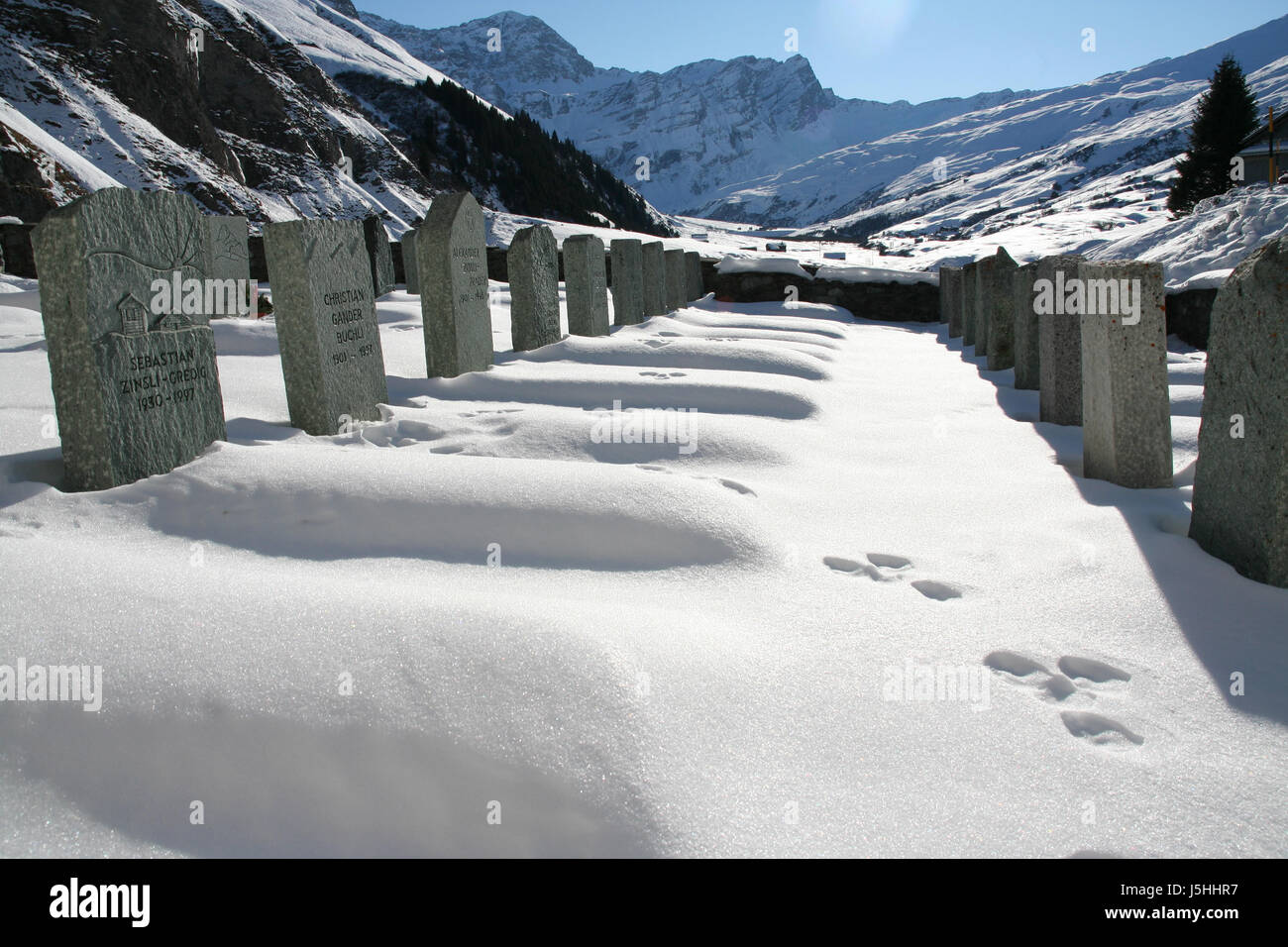 cemetery in mountain village with animal tracks Stock Photo