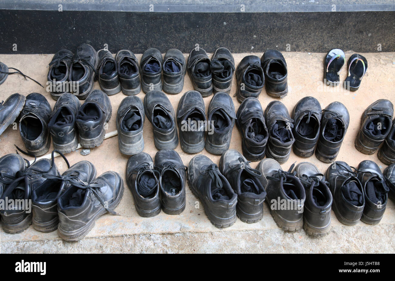 dust black swarthy jetblack deep black shoes mud ankle-strap sandal sandals Stock Photo