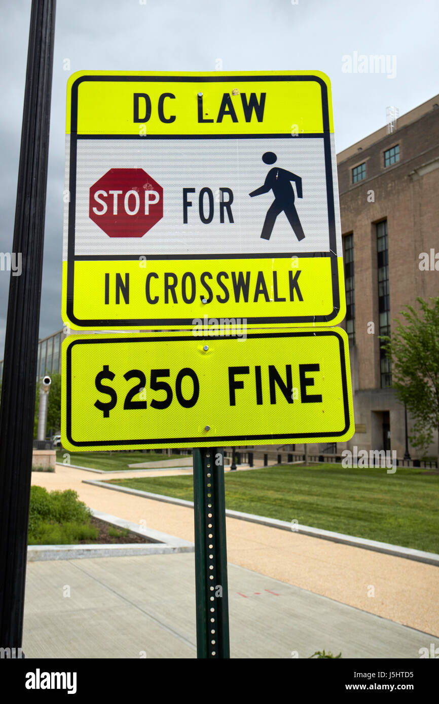 pedestrian crossing crosswalk with warning signs about 250 usd fine for not stopping Washington DC USA Stock Photo