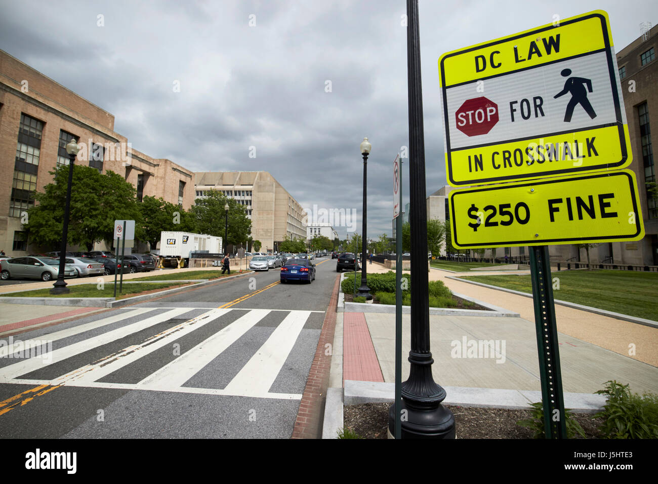 pedestrian crossing crosswalk with warning signs about 250 usd fine for not stopping Washington DC USA Stock Photo
