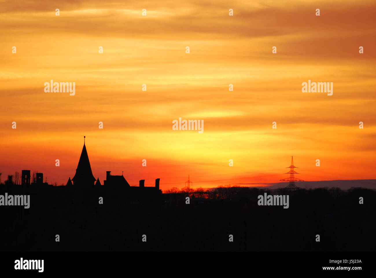 tower shine shines bright lucent light serene luminous houses city town sunset Stock Photo