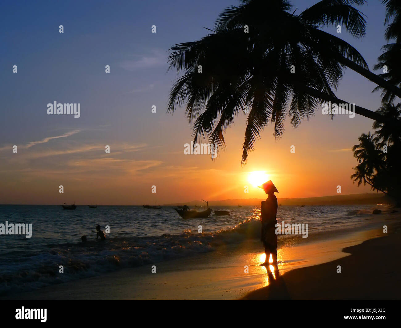 asia sunset hat beach seaside the beach seashore waves counter-light palm tree Stock Photo