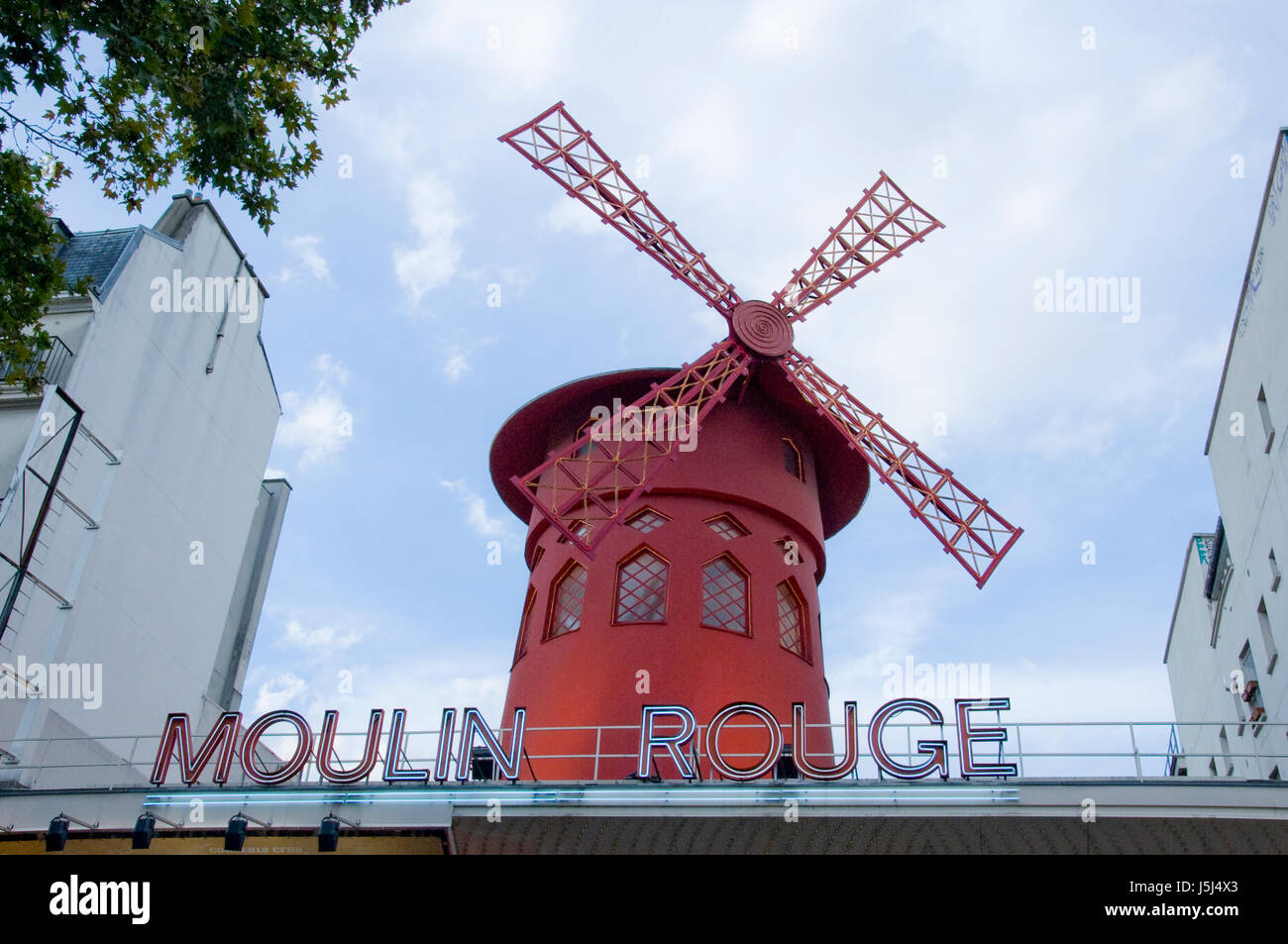 low angle view of the red windmill and sign at the Moulin Rouge in Montmartre, Paris, France. Stock Photo