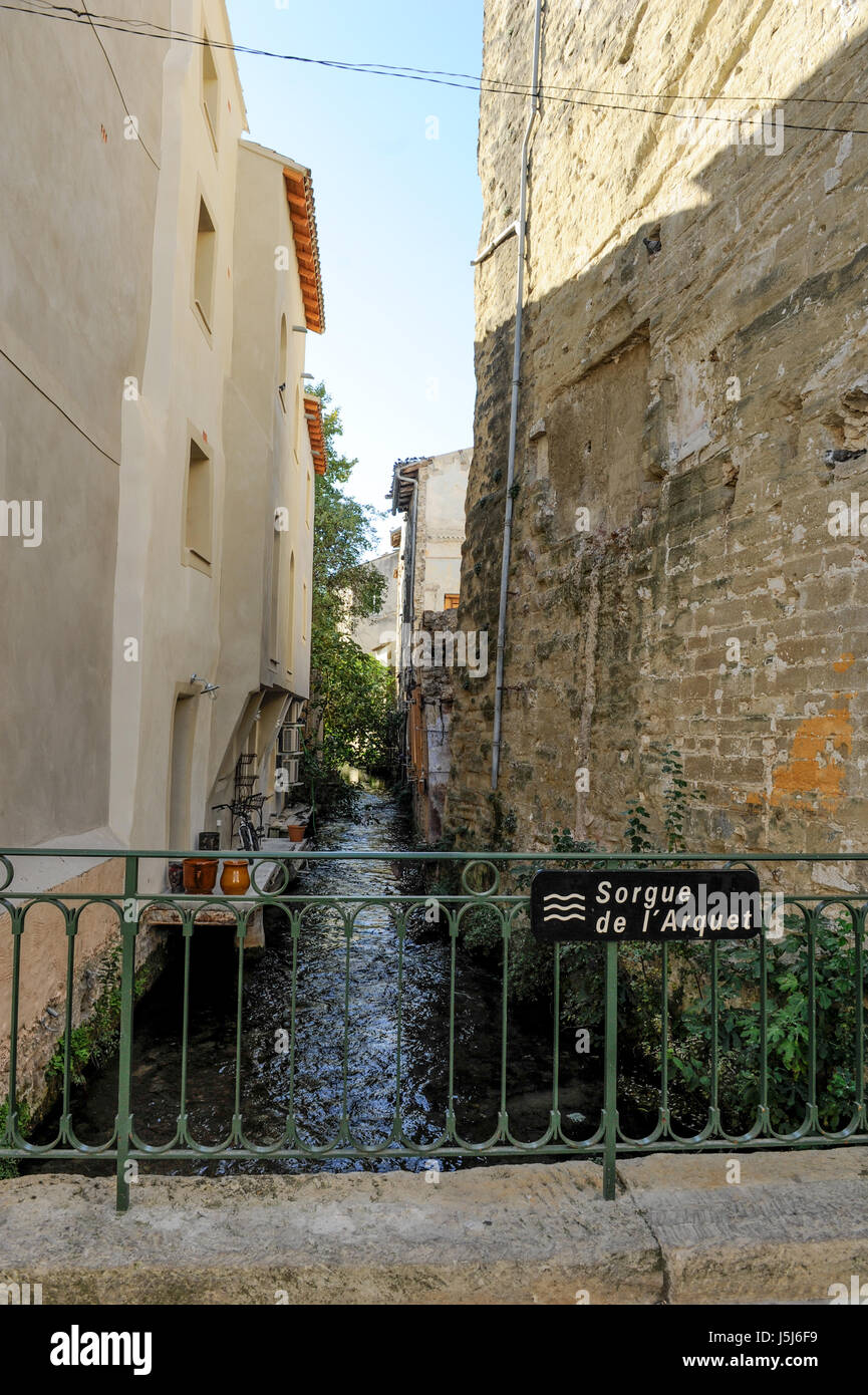 Narrow waterway and bridge, L'Isle-sur-la-Sorgue. France Stock Photo