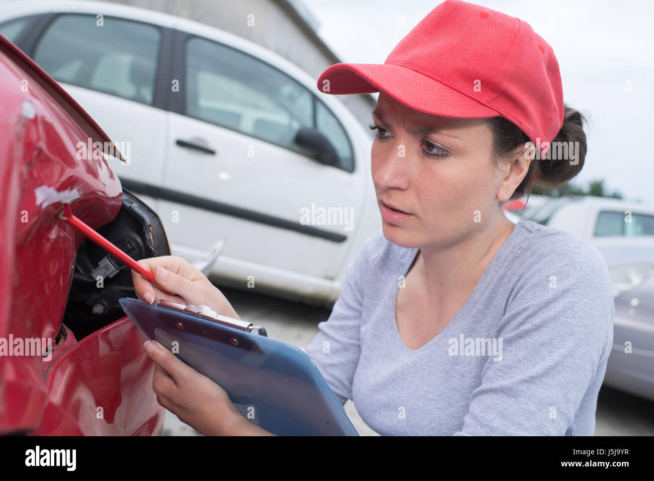 doing an estimate for the car repair Stock Photo Alamy