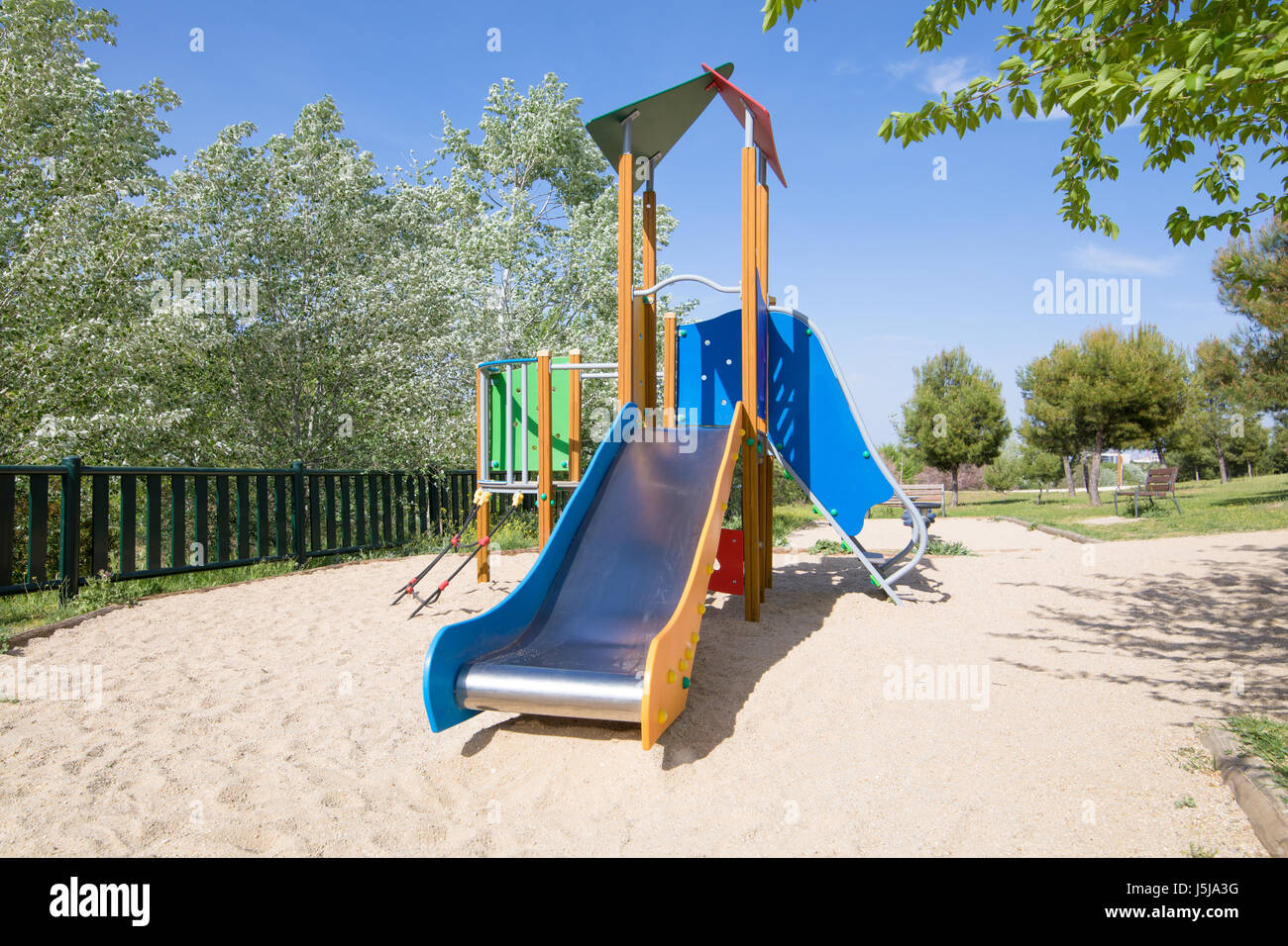 lonely metal slide in outdoor playground, in public Park Valdebebas