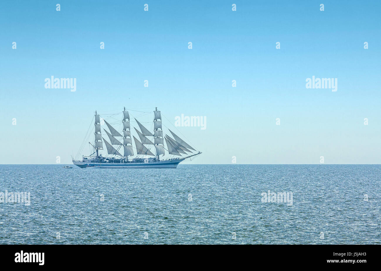 Three masted windjammer in full sails on the Black Sea on the horizon. Stock Photo