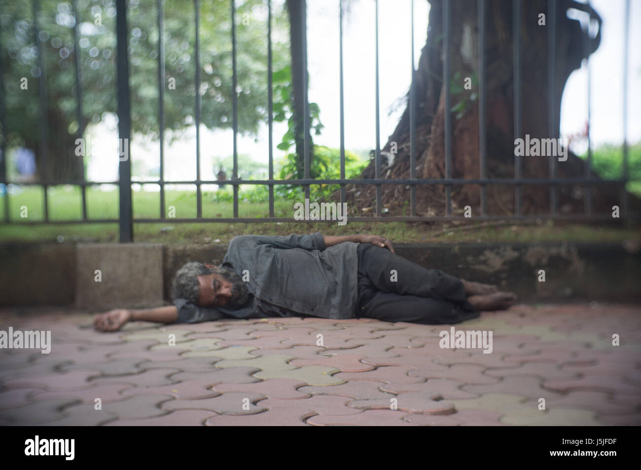 Homeless man sleeping on the streets of Mumbai. Stock Photo