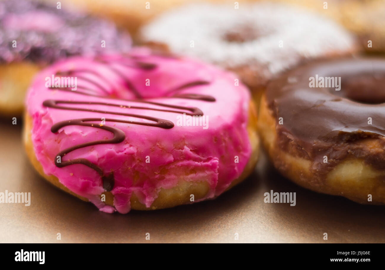Close up of a delicious assorted donuts of different glazed in a soft ...