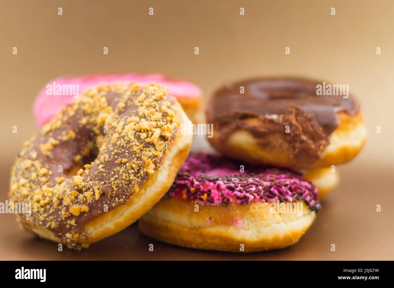 Delicious assorted donuts with chocolate frosted, pink glazed and ...