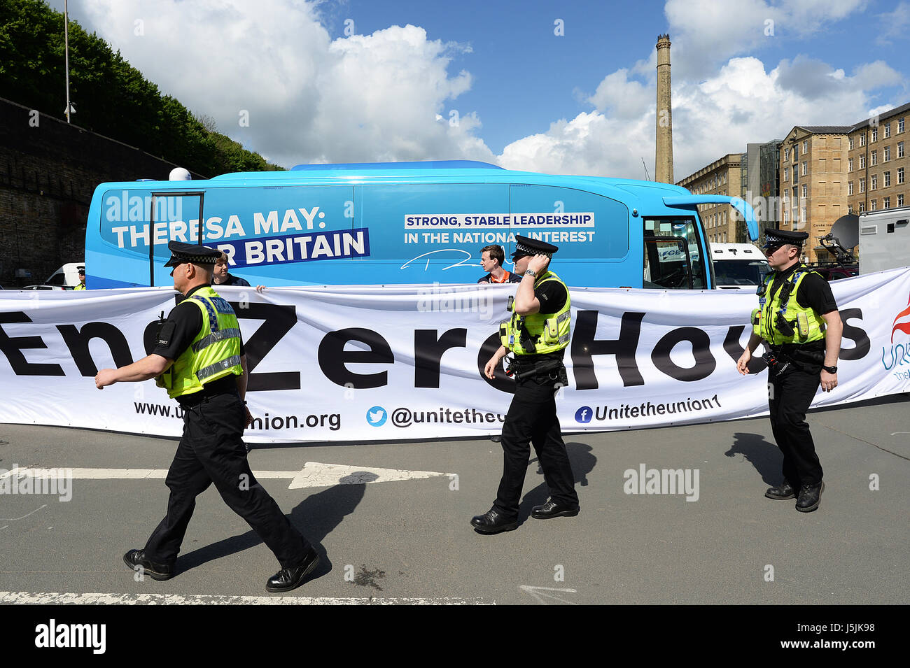 Police and protestors outside the venue in Halifax, West Yorkshire before Conservative Party leader Theresa May launches her party's general election manifesto. Stock Photo