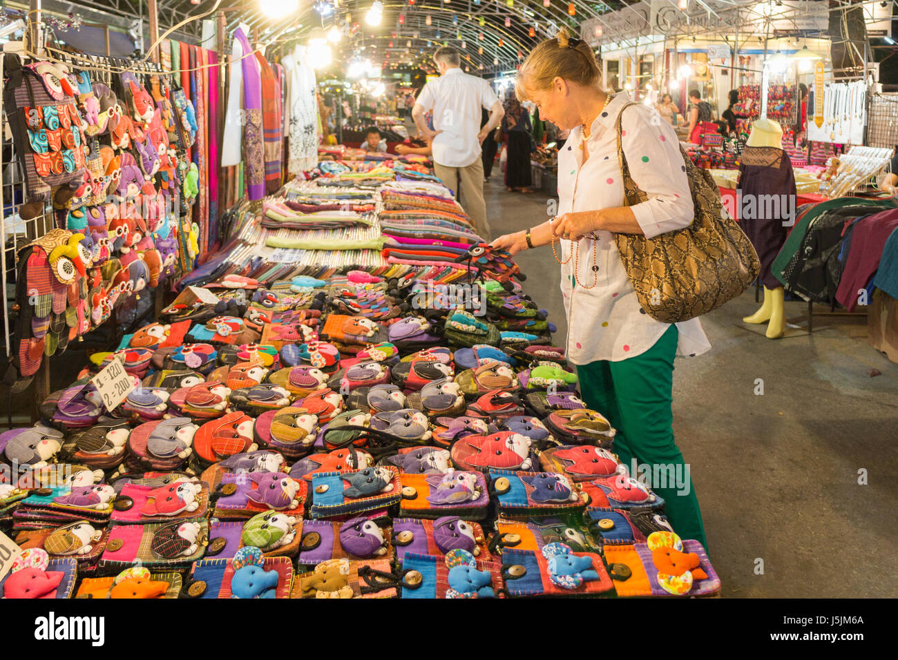 A woman tourist looks at goods on a market stall on Mae Hong Son night market, Thailand Stock Photo