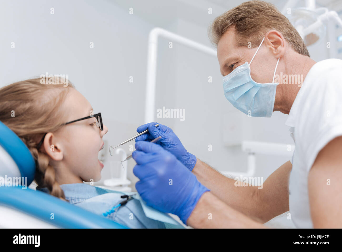 Experienced trained dentist doing his job Stock Photo Alamy