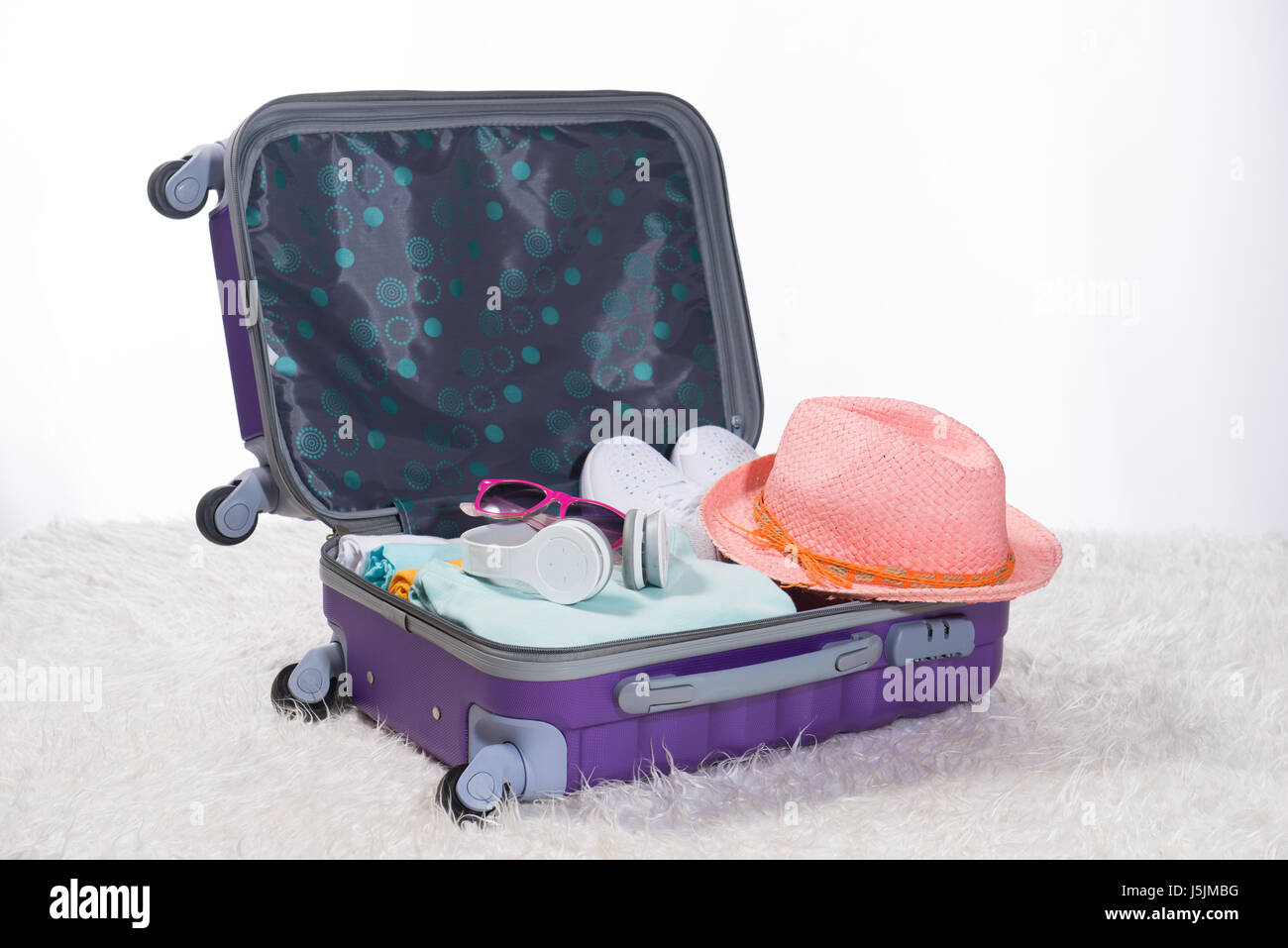 Open suitcase with different men clothes and accessories on sofa Stock  Photo - Alamy