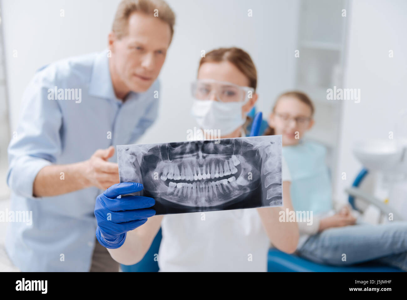 Observant determined dentist indicating problems Stock Photo