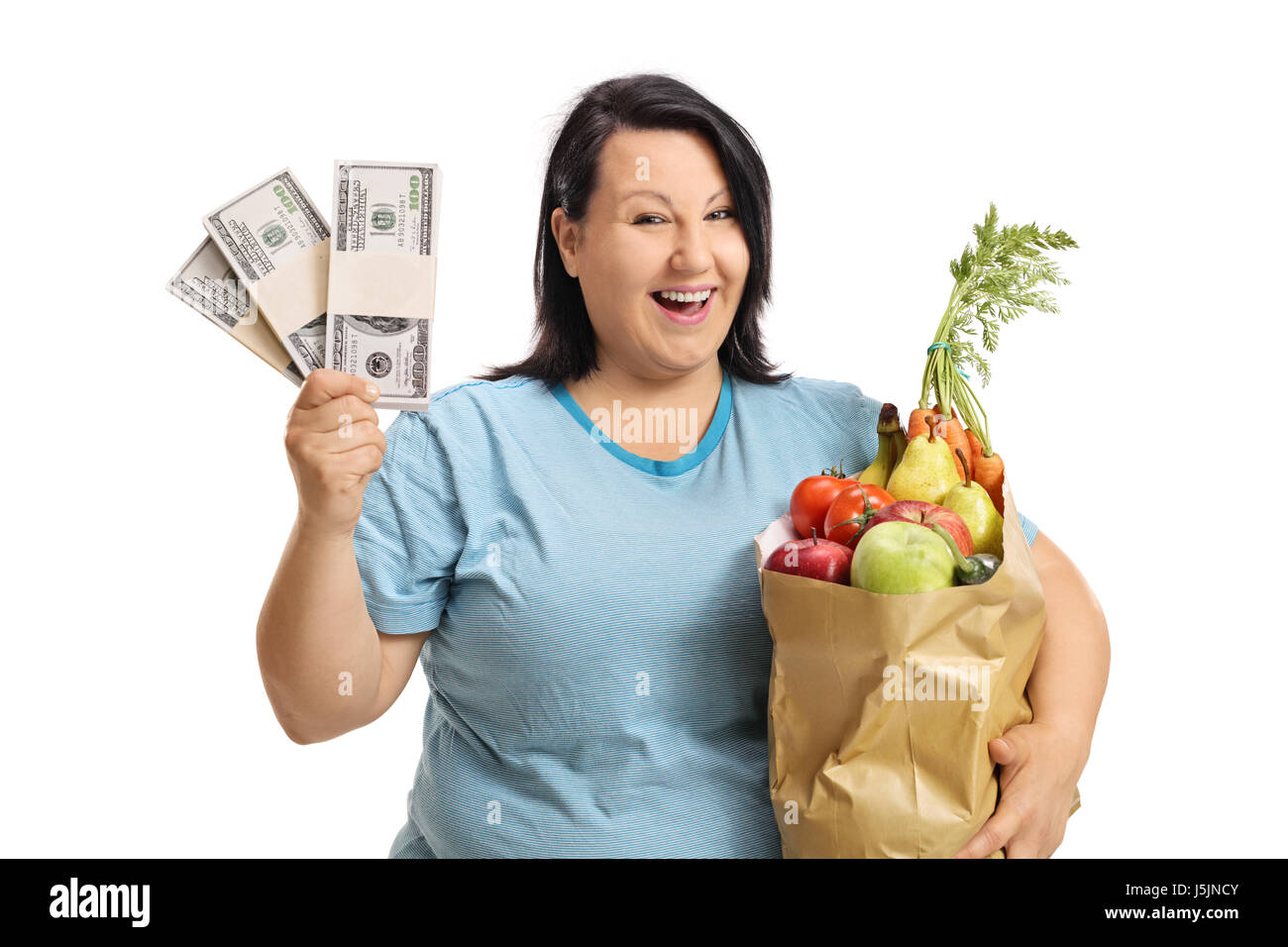 Joyful overweight woman with bundles of money and a bag filled with groceries isolated on white background Stock Photo