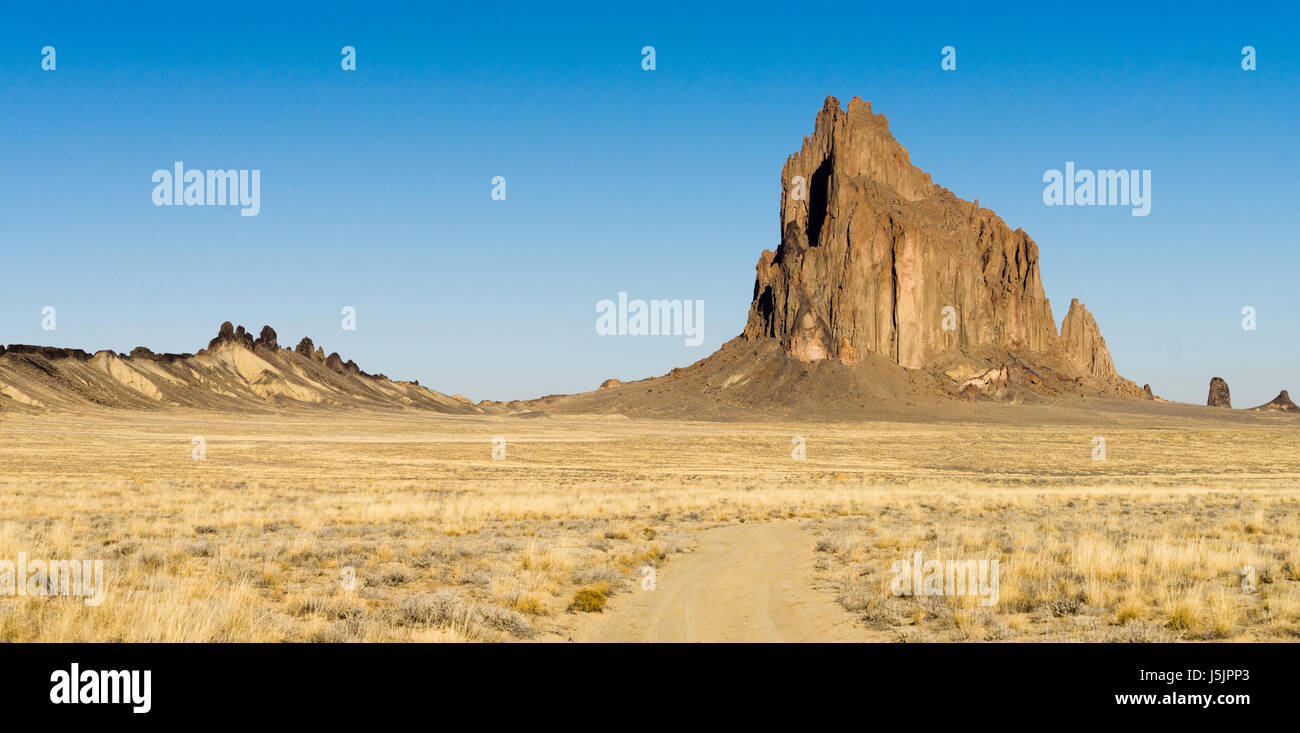 Blue skies appear in a panoramic view of Ship Rock Stock Photo