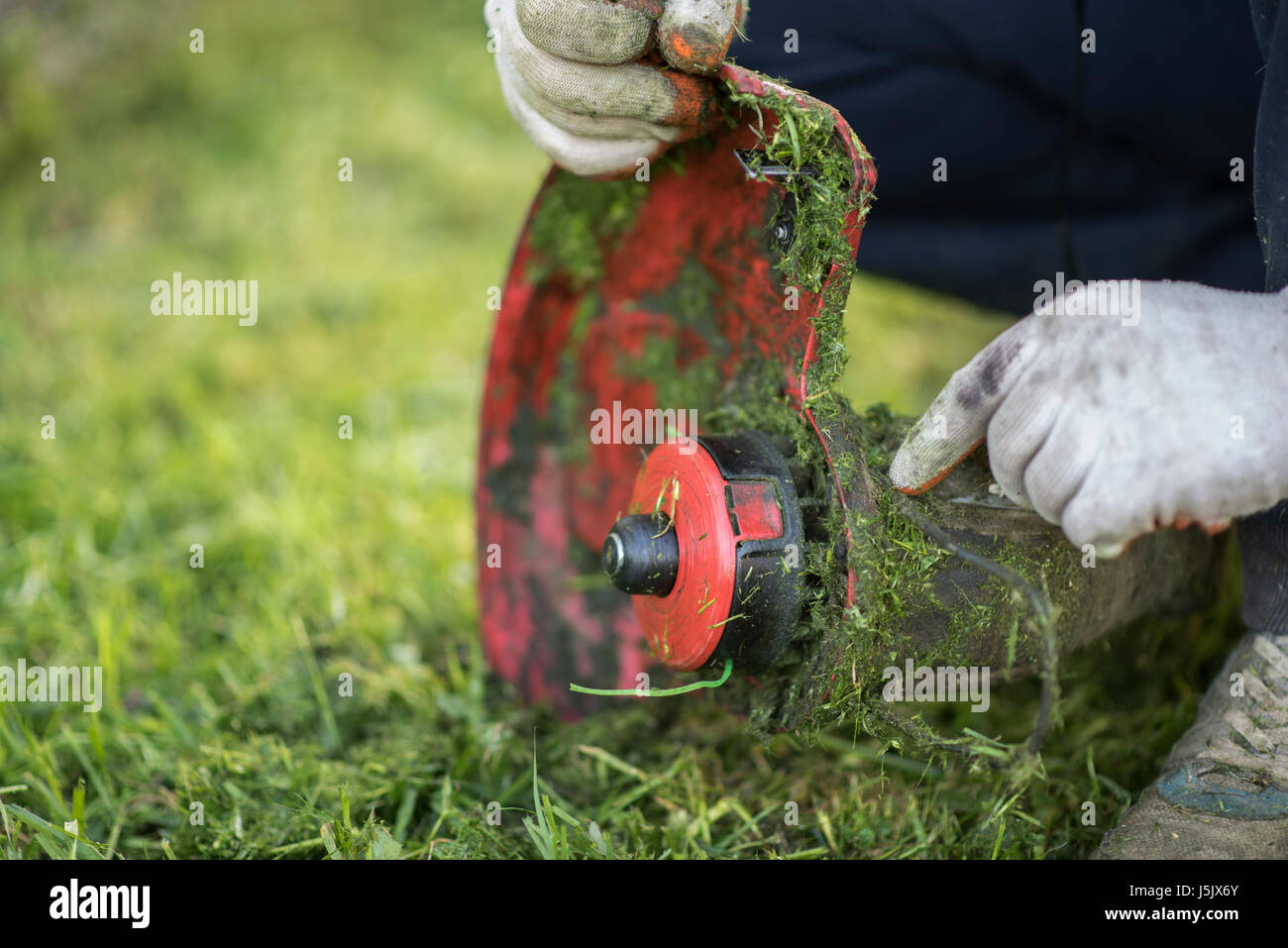 String trimmer cleaning after cutting the grass Stock Photo
