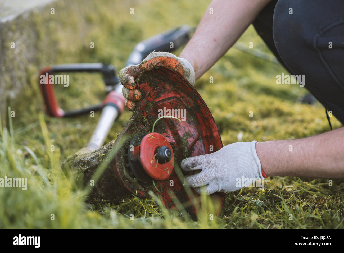 String trimmer cleaning after cutting the grass Stock Photo Alamy