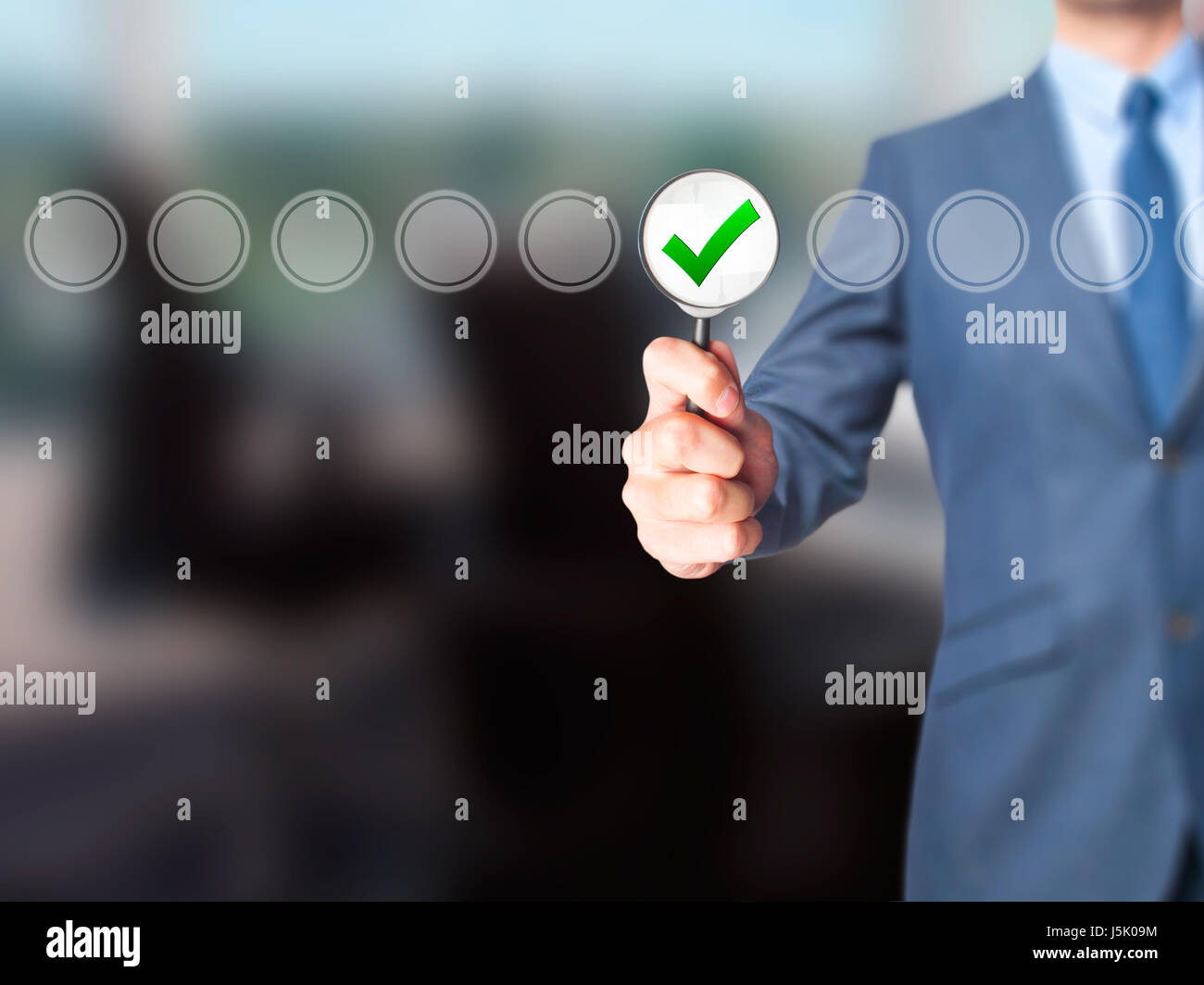 Businessman magnifying glass check mark on virtual screen. Magnifying ...