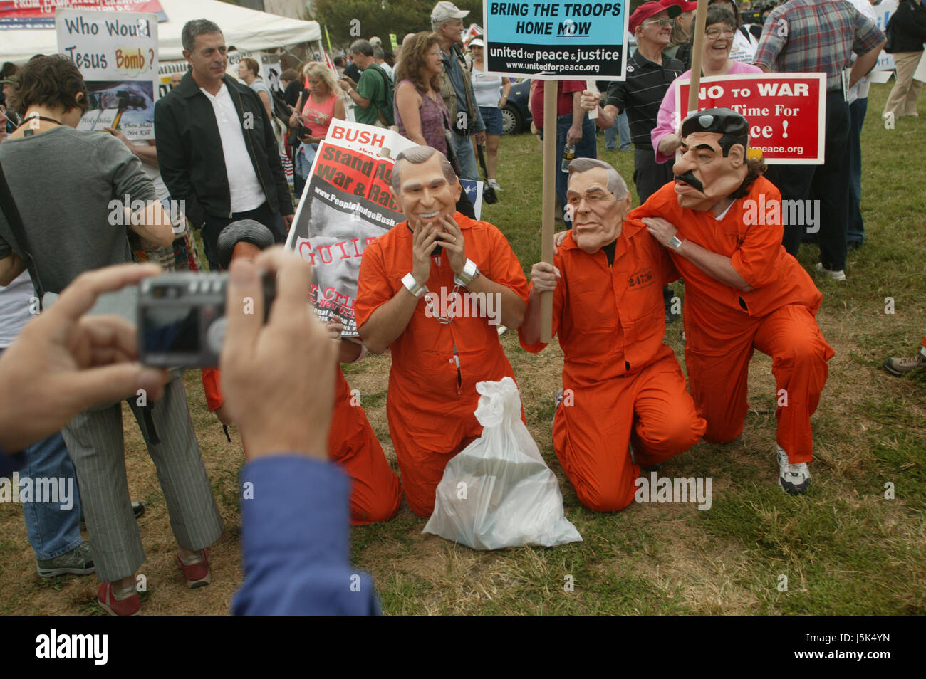 Bush, Rumsfeld and Hussein impersonators are photographed during the anti-war march on Washington. Stock Photo
