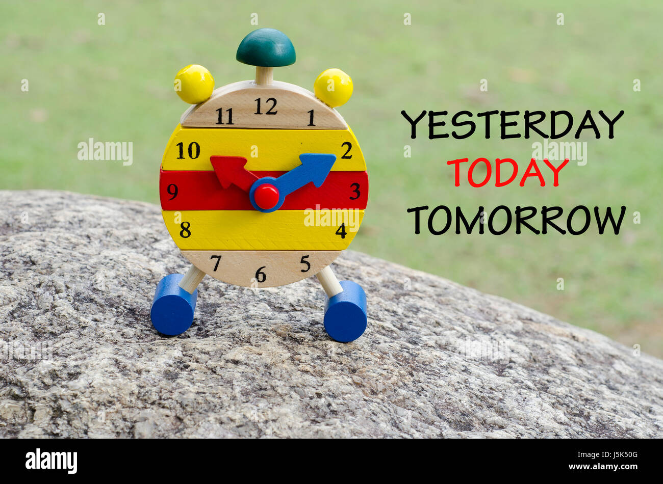 word yesterday today tomorrow on picture of wooden clock. Stock Photo