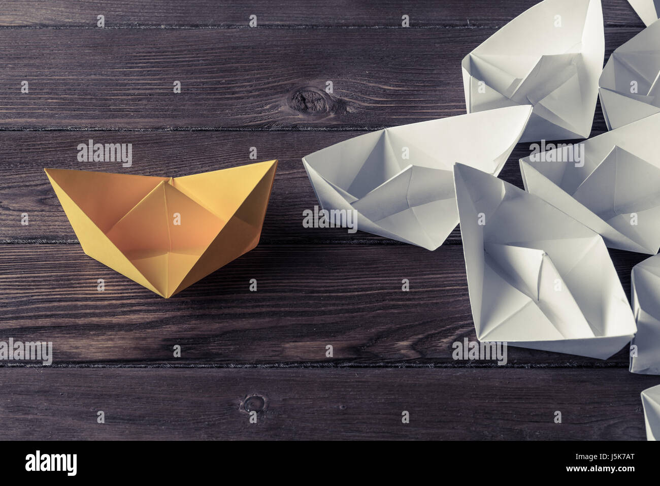 Business leadership concept with white and color paper boats on  Stock Photo