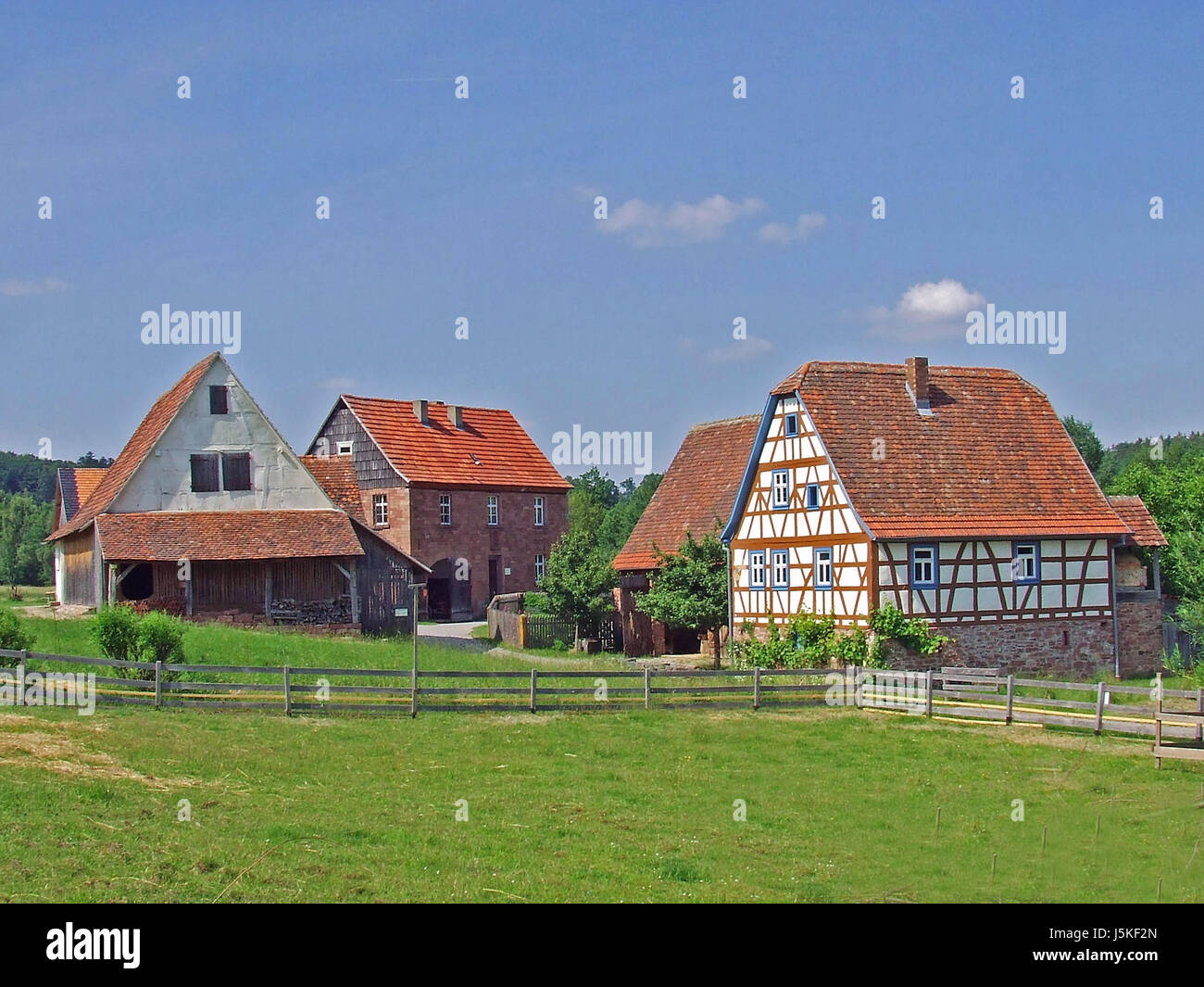houses bucolic landlive idyll farmhouses meadow scenery countryside nature Stock Photo