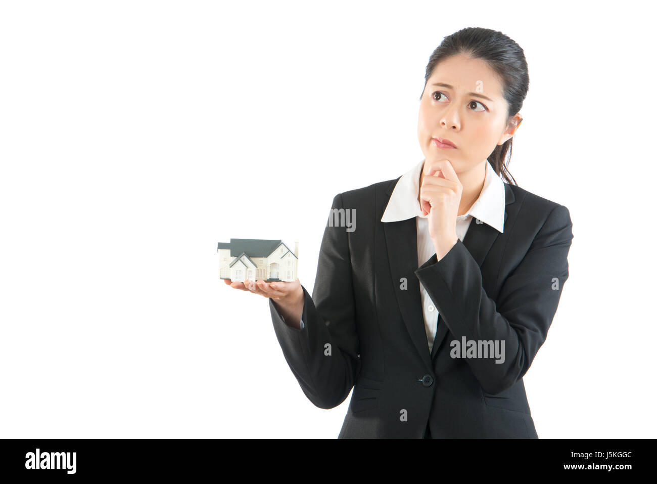 professional asian lawyer thinking house solutions standing on white background. beautiful office lady have house problem. Stock Photo