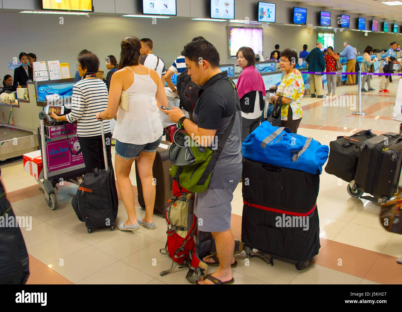 CHIANG MAI, THAILAND - JAN 12, 2017: People waiting in queue at check-in counter in airport. Chiang Mai International Airport  is an international air Stock Photo