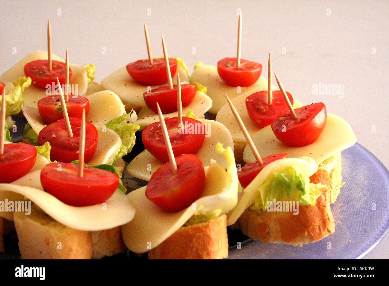 green disc cheese white bread occupied toothpick snack red schnittchen Stock Photo