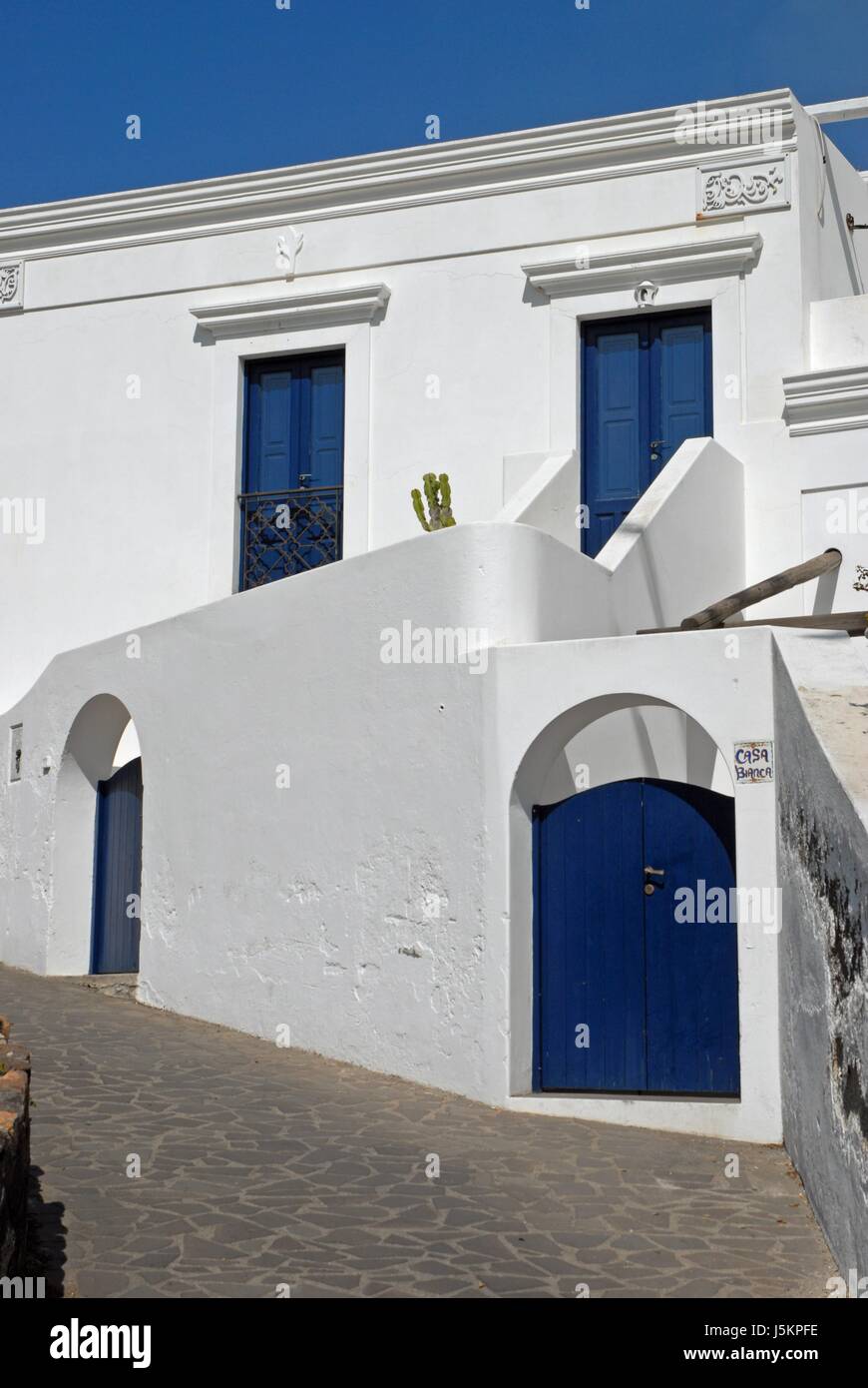 white house with blue windows and doors Stock Photo - Alamy