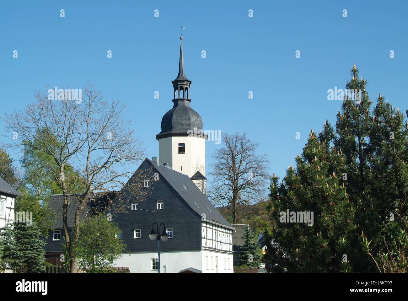 house building tree frame-work erz-mountains steeple tradition church green Stock Photo